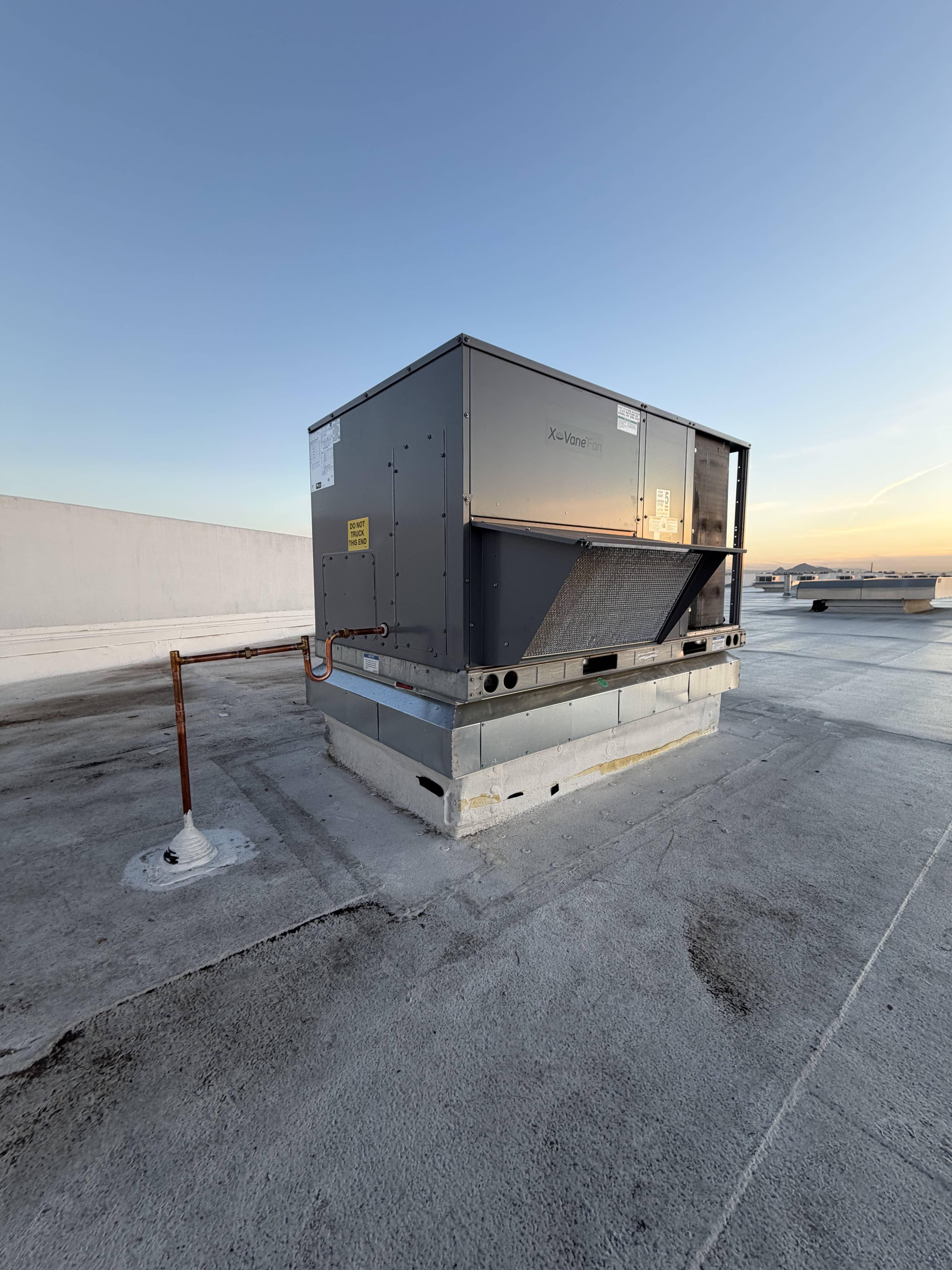 Technician working on an HVAC unit outdoors
